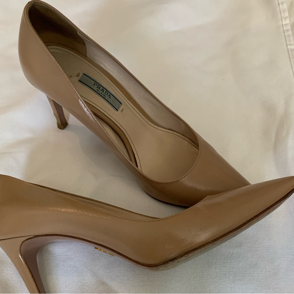 Nude patent leather Prada pumps